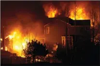  ?? DAVID ZALUBOWSKI — THE ASSOCIATED PRESS ?? Homes burn as wildfires rip through a developmen­t Thursday, Dec. 30, 2021, in Superior, Colo.