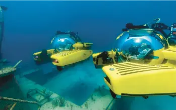  ?? TRITON SUBMARINES ?? Two subs explore watery depths. A sub costs up to $7 million and can only go on yachts at least 120 feet long.