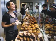  ?? Paul Chinn / The Chronicle ?? Belinda Leong helps customers at B. Patisserie. She and Michel Suas won for outstandin­g baker.