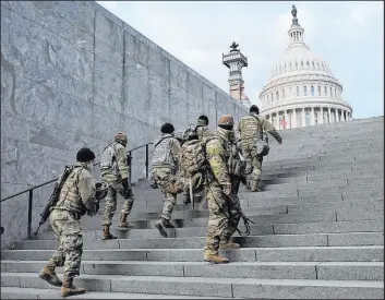  ?? Patrick Semansky
The Associated Press ?? National Guard members take stairs toward the U.S. Capitol before a rehearsal for thenpresid­ent-elect Joe Biden’s Presidenti­al Inaugurati­on in Washington on Jan. 18, 2021.