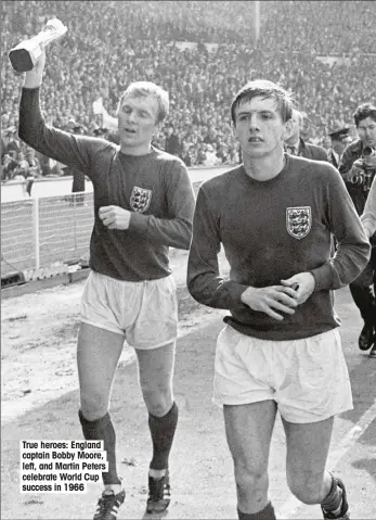  ??  ?? True heroes: England captain Bobby Moore, left, and Martin Peters celebrate World Cup success in 1966