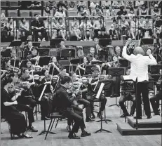  ?? PHOTOS BY JIANG WENLONG / FOR CHINA DAILY ?? Conductor Chen Xieyang and Suzhou Symphony Orchestra perform at Jinji Lake Concert Hall in Suzhou, Jiangsu province, July 15.