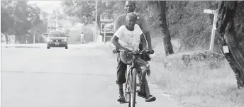  ??  ?? An elderly couple shares a bicycle from Queens Park to the city centre in Bulawayo recently