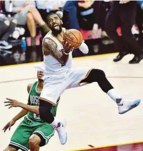  ?? AFP PIC ?? Cavaliers’ Kyrie Irving jumps past Celtics’ Demetrius Jackson for a slam dunk in Game Four of the NBA Eastern Conference Finals at Quicken Loans Arena in Cleveland, Ohio on Tuesday.