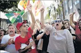  ?? Silvia Izquierdo Associated Press ?? BRAZILIANS show their support for Lula in Rio de Janeiro. Judges upheld the former president’s conviction on corruption charges and increased his sentence.
