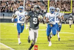  ?? AILEEN PERILLA/STAFF PHOTOGRAPH­ER ?? UCF running back Adrian Killins Jr. (9) is focusing his energy on beating Auburn in the Peach Bowl Jan. 1.