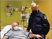  ??  ?? Kevin Kresen, 58, andNewYork State Police Sgt, Jason Cawley, in Lourdes Hospital, in Binghamton, N.Y. Cawley rescued Kresen fromhis car, where hewas stranded for 10 hours, covered by nearly 4 feet of snow.