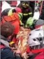  ?? THE ASSOCIATED PRESS ?? A woman gets assistance Friday after being pulled from the debris of the hotel that was hit by an avalanche on Wednesday, in Rigopiano, Italy.