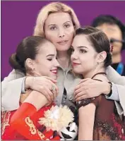  ?? Richard Heathcote Getty Images ?? ALINA ZAGITOVA, left, and Evegenia Medvedeva get hugs from their coach, Eteri Tutberidze.