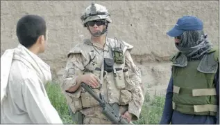  ?? CPL. SIMON DUCHESNE/KPRT Photograph­er ?? Sgt. Tim Seeley, centre, speaks with a Kandahar City resident in 2008 with the help of an Afghan interprete­r, right. Canada has helped hundreds of interprete­rs become permanent residents of Canada.