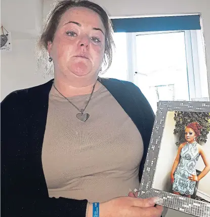  ??  ?? Torment: Ms Sheehan with a picture of Kayleigh