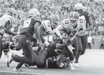  ?? MARK WALLHEISER AP ?? Florida quarterbac­k Feleipe Franks is brought down just short of the goal line by Florida State defensive back Jaiden Woodbey (20) in the first half of the Gators’ 41-14 victory on Saturday at Doak Campbell Stadium in Tallahasse­e.