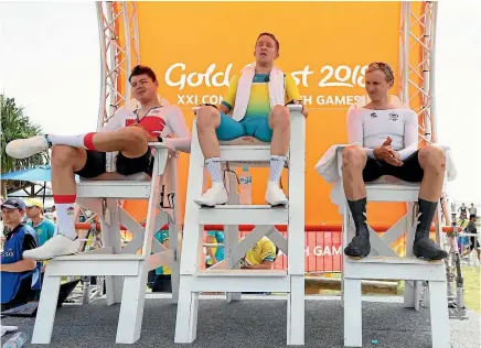  ?? PHOTO: GETTY IMAGES ?? Hamish Bond, right, takes his place in the bronze medallist’s seat, alongside English runner-up Harry Tanfield, left, and Australian winner Cameron Meyer after the individual time trial.