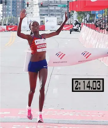  ?? — AFP ?? Brigid Kosgei of Kenya celebrates breaking the world record to win the Bank of America Chicago Marathon in Chicago, Illinois, on Sunday.