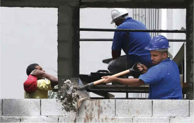  ?? Reuters ?? Workers at the constructi­on site of a residentia­l building in Sao Paulo, Brazil.