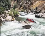  ?? COURTESY OF FRESNO COUNTY SHERIFF ?? A car sits in the middle of Kings River. The car plunged off a cliff into the swollen river more than a month ago.