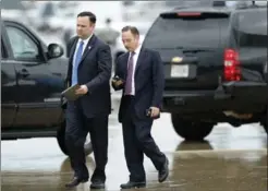  ?? ALEX BRANDON, THE ASSOCIATED PRESS ?? White House director of social media Dan Scavino, left, walks with former White House chief of staff Reince Priebus as they arrive Friday at Andrews Air Force Base, Md.