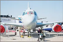  ?? (AP) ?? A man walks past with his bicycle a Japan maritime self-defense forces P-1 submarine-hunting aircraft, at Paris Air Show, on the eve of its opening, in Le Bourget, east of Paris, France on June 18. While Airbus and Boeing will again hog the spotlight...