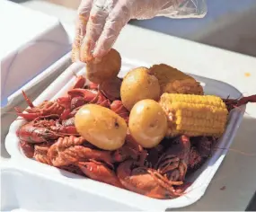  ?? CHRISTINE TANNOUS/THE COMMERCIAL APPEAL ?? Crawfish, shrimp, sausage, potatoes and corn from Glaze’s Crawfish at Max’s Sports Bar.