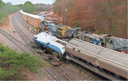  ??  ?? Two Amtrak employees were killed and more than 100 people injured when the Miami-bound train struck an idling freight train early Sunday in Cayce, S.C. Authoritie­s said the Amtrak train was on the wrong track. TIM DOMINICK/THE STATE VIA AP