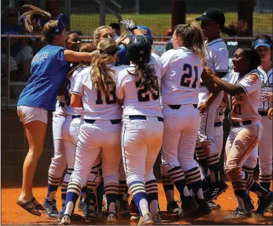  ?? Arkansas Democrat-Gazette/THOMAS METTHE ?? North Little Rock’s Katelynn McMahan is congratula­ted after hitting a home run in the bottom of the sixth inning of North Little Rock’s 14-3 victory over Rogers Heritage in the Class 7A state softball tournament Thursday in Cabot.