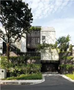  ??  ?? Above: The ‘introverte­d’ facade of the Grotto House is articulate­d with board-form concrete and timber – materials that will age gracefully. Opposite: Staggered floor plates allow for visual connectivi­ty from the basement all the way to the second floor.