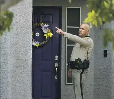  ?? John Locher Associated Press ?? A POLICE OFFICER stands outside Clark County Public Administra­tor Robert Telles’ house in Las Vegas on Wednesday. Authoritie­s arrested Telles later that day in last week’s stabbing death of reporter Jeff German.