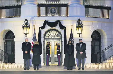  ?? EVAN VUCCI — THE ASSOCIATED PRESS ?? From left, President Joe Biden, First Lady Jill Biden, Vice President Kamala Harris and her husband Doug Emhoff, bow their heads during a ceremony to honor the 500,000 Americans that died from COVID-19, at the White House Feb. 22, in Washington.