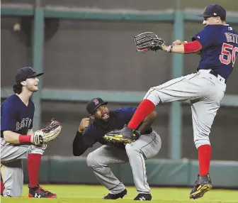  ?? AP PHOTO ?? STAR OF THE SHOW: Mookie Betts (right) celebrates with fellow outfielder­s Andrew Benintendi (left) and Jackie Bradley Jr. after the Sox beat the Astros last night, 2-1.