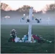  ?? GERALD HERBERT/AP FILE PHOTO ?? Morning fog surrounds memorials placed for the 17 who died in the shooting at Marjory Stoneman Douglas High School in Parkland, Fla., in February 2018. Onethird of the attackers who terrorized schools, houses of worship or businesses nationwide last year had a history of serious domestic violence, according to a U.S. Secret Service report.