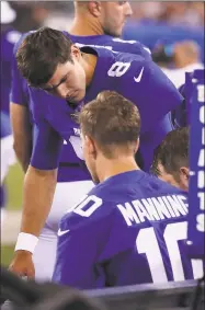  ?? Al Bello / Getty Images ?? The Giants’ Daniel Jones speaks with Eli Manning during a preseason game against the Jets on Thursday.