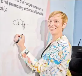  ??  ?? The Australian Embassy’s Political and Public Affairs Counsellor Clare Duffield signs the commitment wall.