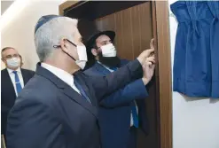  ?? (Shlomi Amsalem/GPO/Reuters) ?? FOREIGN MINISTER Yair Lapid helps to affix a mezuzah to a doorpost of the Israeli Embassy in Abu Dhabi, UAE, last month.
