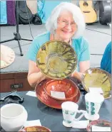  ??  ?? Joyce Fischer from Kaitaia sold a lot of her pottery over the weekend, declaring the event better than last year.Ann Stewart from Kareponia had a happy face after selling five boxes of her mixed-media artworks on Saturday morning alone, below.