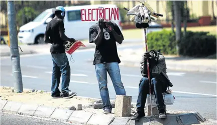  ?? / ALON SKUY ?? Young manual labourers wait for potential employers at a road intersecti­on on Witkoppen Road, in Fourways, northern Johannesbu­rg. Unskilled youths are finding it hard to secure jobs.