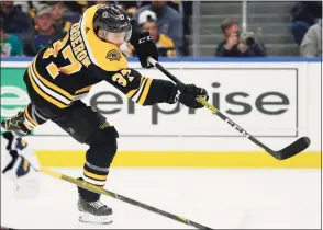  ?? Jeffrey T. Barnes / Associated Press ?? Boston Bruins forward Patrice Bergeron shoots during the second period against the Buffalo Sabres last season in Buffalo, N. Y.