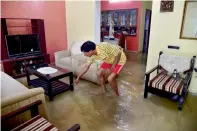  ?? PTI ?? A resident wades through the clogged rain water at his house in a low-lying locality in Bengaluru on Tuesday. —