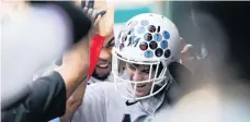  ?? ALEX BRANDON AP ?? Brian Anderson wears the Marlins’ celebrator­y football helmet in the dugout after hitting a solo homer to open the scoring in the third inning.