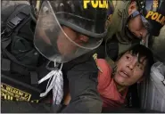  ?? MARTIN MEJIA — THE ASSOCIATED PRESS ?? An anti-government protesters who traveled to the capital from across the country to march against Peruvian President Dina Boluarte, is detained and thrown on the back of police vehicle during clashes in Lima, Peru, Thursday.