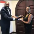  ??  ?? UKZN Vice-Chancellor and Principal, Professor Nana Poku, receives a token of appreciati­on from Mpume Nyandu.