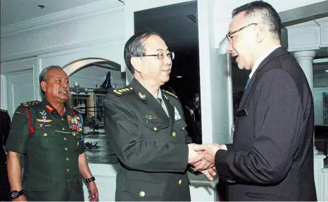  ??  ?? Strong ties: Hishammudd­in receiving a courtesy call from General Fang (centre). With them is Armed Forces Chief Jen Tan Sri Zulkifeli Mohd Zin (left). — Bernama