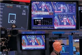  ?? AP PHOTO/RICHARD DREW ?? On Wednesday, screens on the floor of the New York Stock Exchange show the news conference of Federal Reserve Chair Jerome Powell.