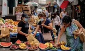  ?? Photograph: Bloomberg/Getty Images ?? Shoppers in Queens, New York City. The US recorded more than 60,000 new coronaviru­s cases in six out of nine days to Wednesday.