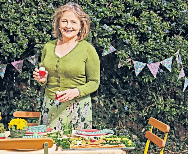  ??  ?? g Xanthe Clay adds the finishing touches to her Easter table