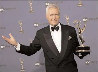  ?? The Canadian Press ?? Alex Trebek is pictured in this 2006 file photo after winning one of his five Emmy Awards as outstandin­g game show host for “Jeopardy.”