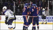  ?? KATHLEEN MALONE-VAN DYKE — THE ASSOCIATED PRESS ?? Islanders players celebrate after Devon Toews’ overtime goal gave them a 3-2 win over the Blues in Unionvale on Monday.