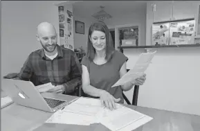  ?? TRIBUNE NEWS SERVICE ?? Jeff Whitehall and Kathryn Jacoby go over their budget at their home in Seattle's Crown Hill neighborho­od.