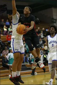  ?? ?? Las Vegas’ Tayshaun Jackson looks to scoop the ball under pressure from Green Valley’s Gaston Zumaya.