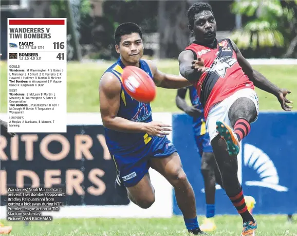  ??  ?? Wanderers’ Nook Mansell can’t prevent Tiwi Bombers opponent Bradley Palipuamin­ni from getting a kick away during NTFL Premier League action at TIO Stadium yesterday Picture: IVAN RACHMAN