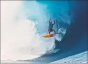  ?? Adventure Entertainm­ent ?? NATHAN FLETCHER, a third-generation surfer, in 2017 jumped from a helicopter into a wave off Oahu.